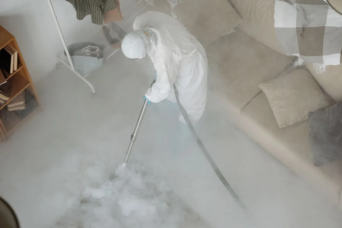 Biohazard cleanup technician in protective equipment, Lyons, CO
